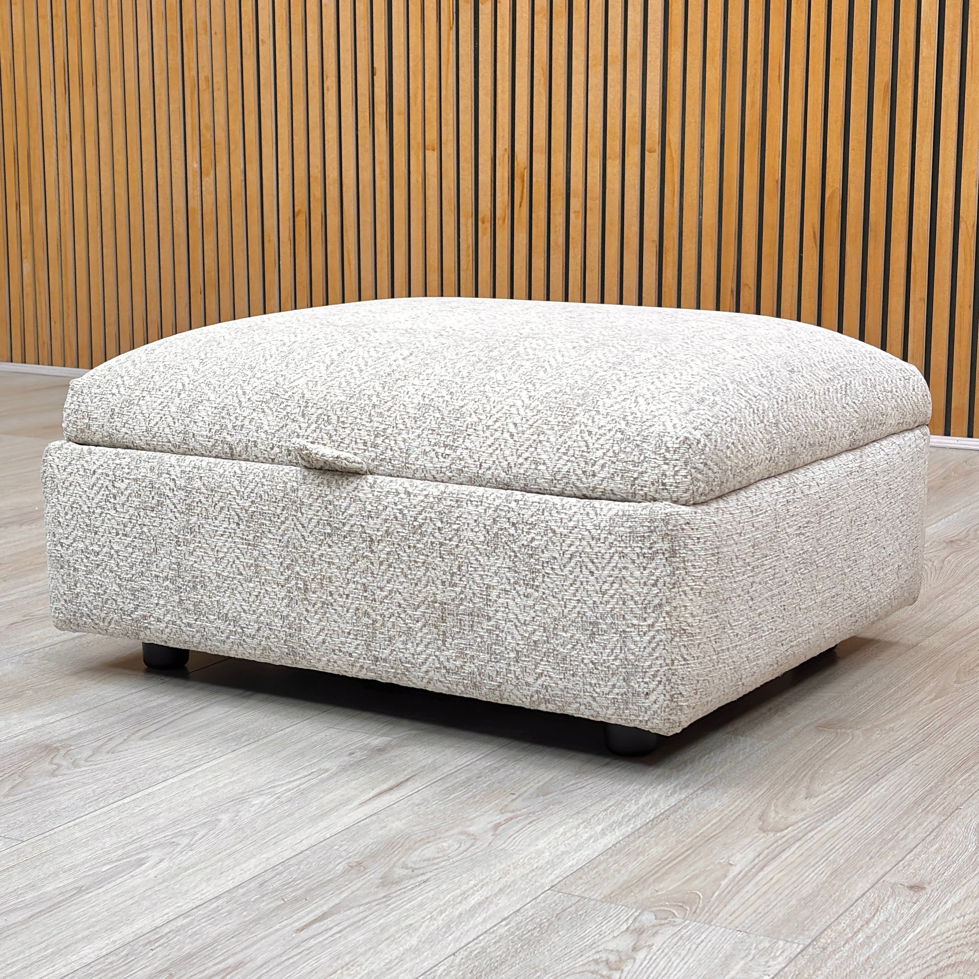 Lifestyle view of the Hudson storage stool with the lid open, revealing the spacious internal compartment designed for storing blankets, cushions, or magazines.