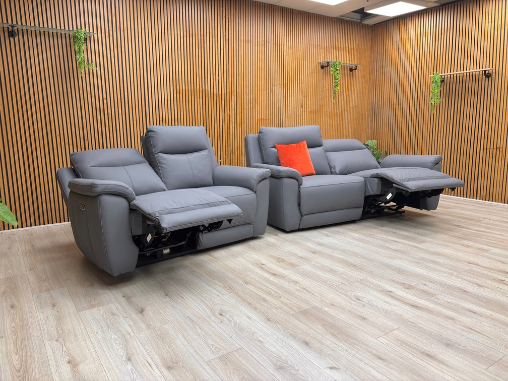 Lifestyle view of the 3-seater Bobby sofa, showcasing the rich navy leather grain and the plush, supportive armrests.