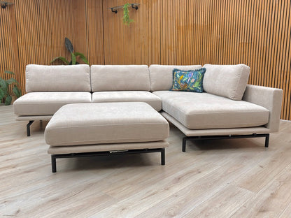 Lifestyle view of the Brixton Taupe Corner Sofa, showing the spacious chaise end and comfortable deep-filled back cushions.
