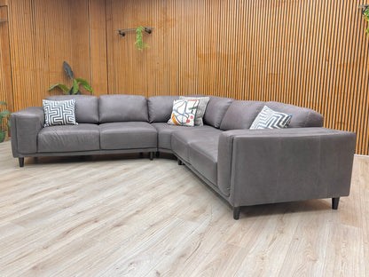 Lifestyle shot of the Brody sofa, highlighting the luxurious sheen of the genuine Italian leather and the clean, structured armrests.