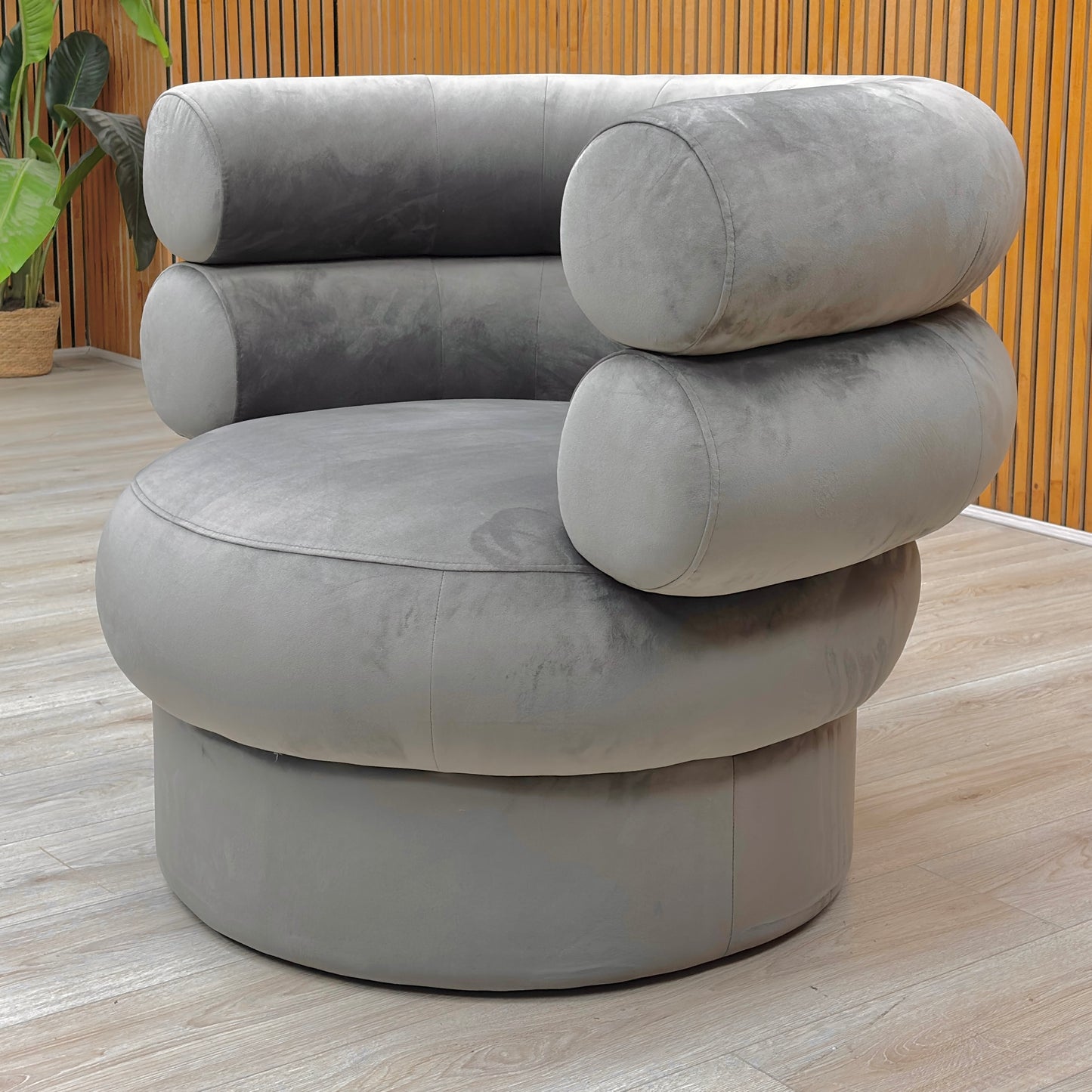 Lifestyle view of the Fitzrovia Charcoal Velvet chair, highlighting the elegant curved backrest and plush seat cushion.