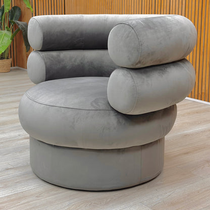 Lifestyle view of the Fitzrovia Charcoal Velvet chair, highlighting the elegant curved backrest and plush seat cushion.