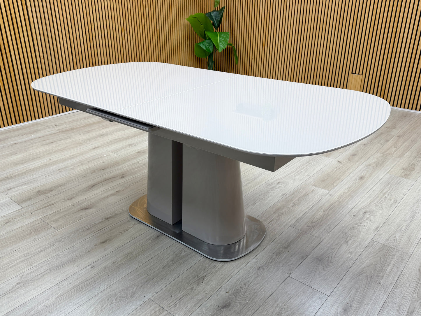 Lifestyle view of the Cashmere table in its standard 180cm length, emphasizing the smooth, high-quality surface texture and contemporary architectural profile.