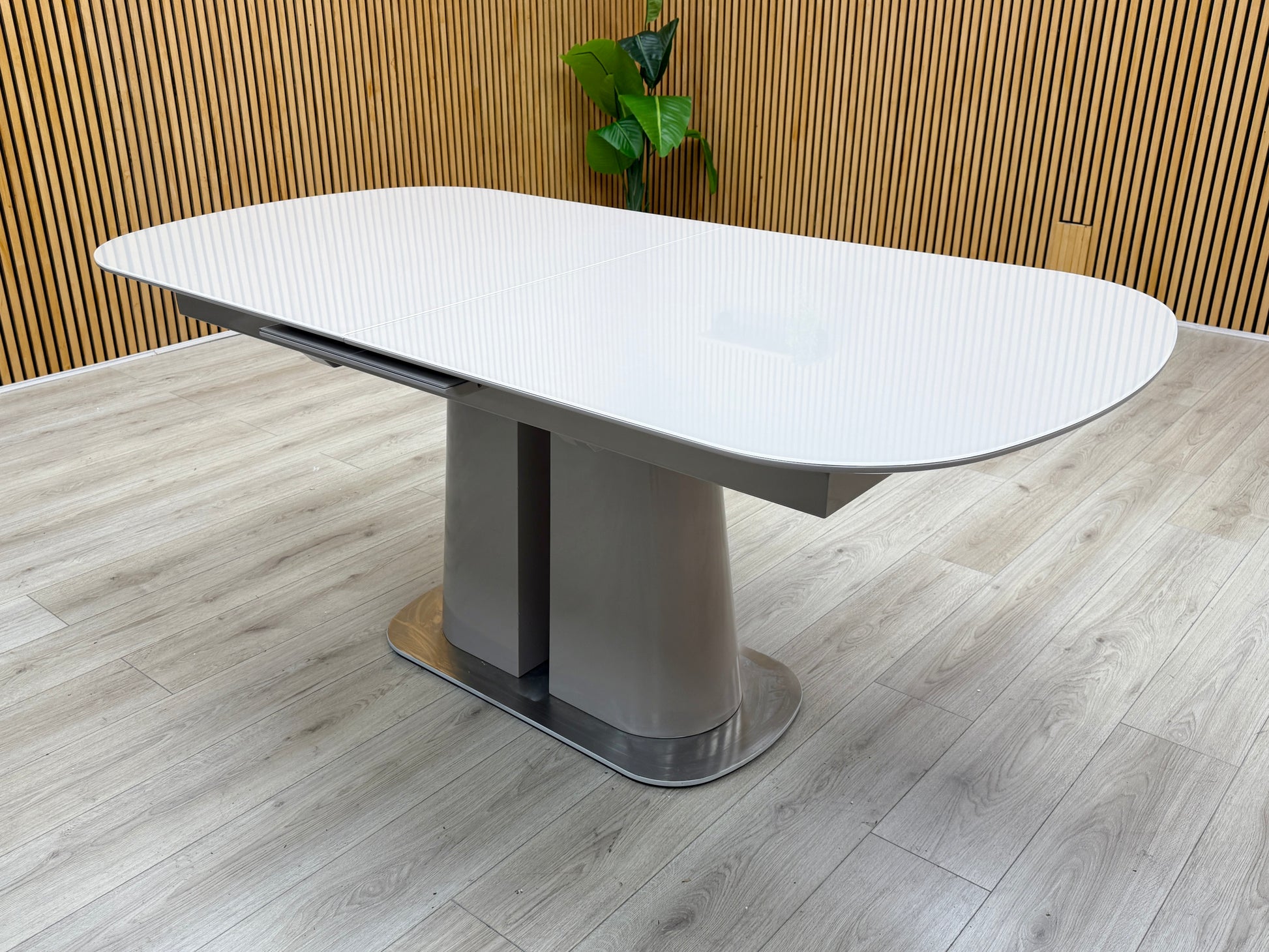 Lifestyle view of the Cashmere table in its standard 180cm length, emphasizing the smooth, high-quality surface texture and contemporary architectural profile.
