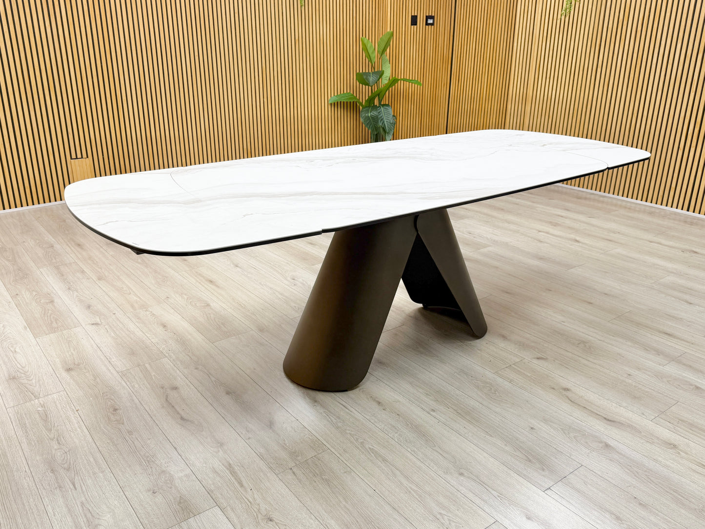 Side profile of the dining table, emphasizing the slim profile of the ceramic top and the heavy-duty support frame.