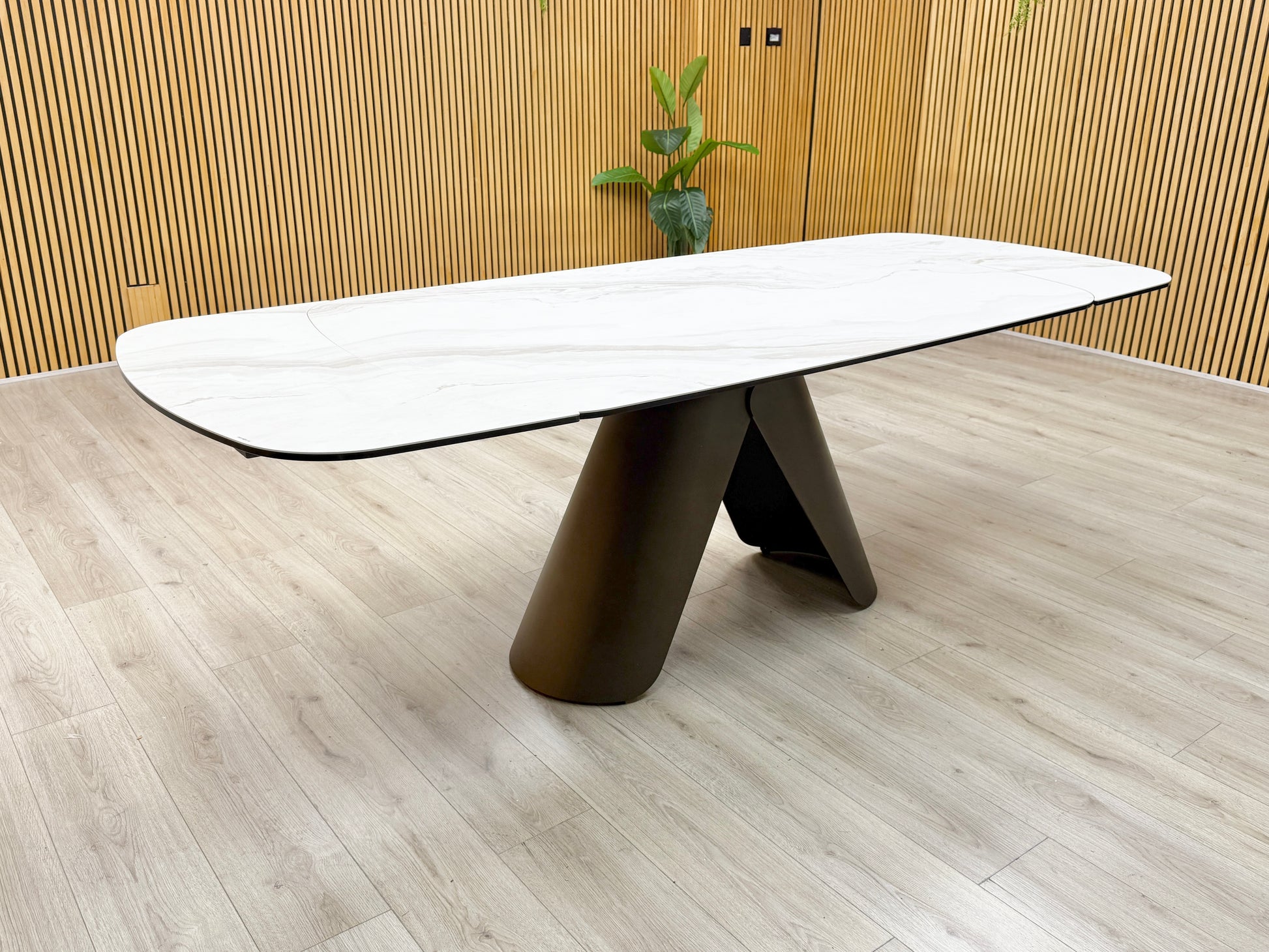 Side profile of the dining table, emphasizing the slim profile of the ceramic top and the heavy-duty support frame.