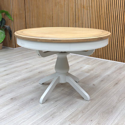 Lifestyle view of the ‘Hamilton’ Solid Oak Round Dining Table, demonstrating the build quality, surface texture, and the stability of the central pedestal.