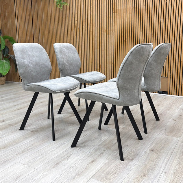 Life Style View of the Montreal dining chair, showcasing its ergonomic frame contour, supporting depth, and tailored fabric stitching.