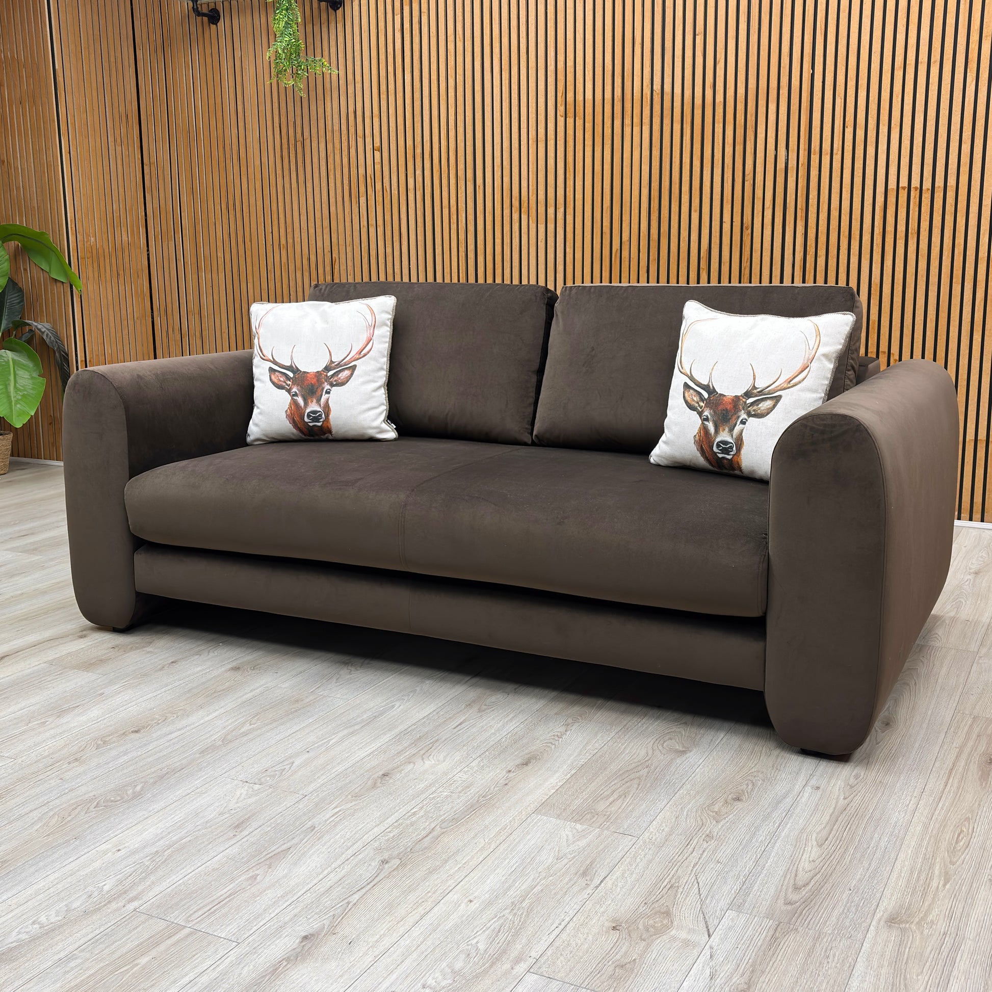Lifestyle Shot shot of the Maserati 3-seater brown velvet sofa, highlighting the luxurious fabric sheen and neat, clean-lined cushioning.