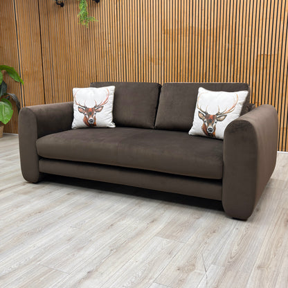 Lifestyle Shot shot of the Maserati 3-seater brown velvet sofa, highlighting the luxurious fabric sheen and neat, clean-lined cushioning.