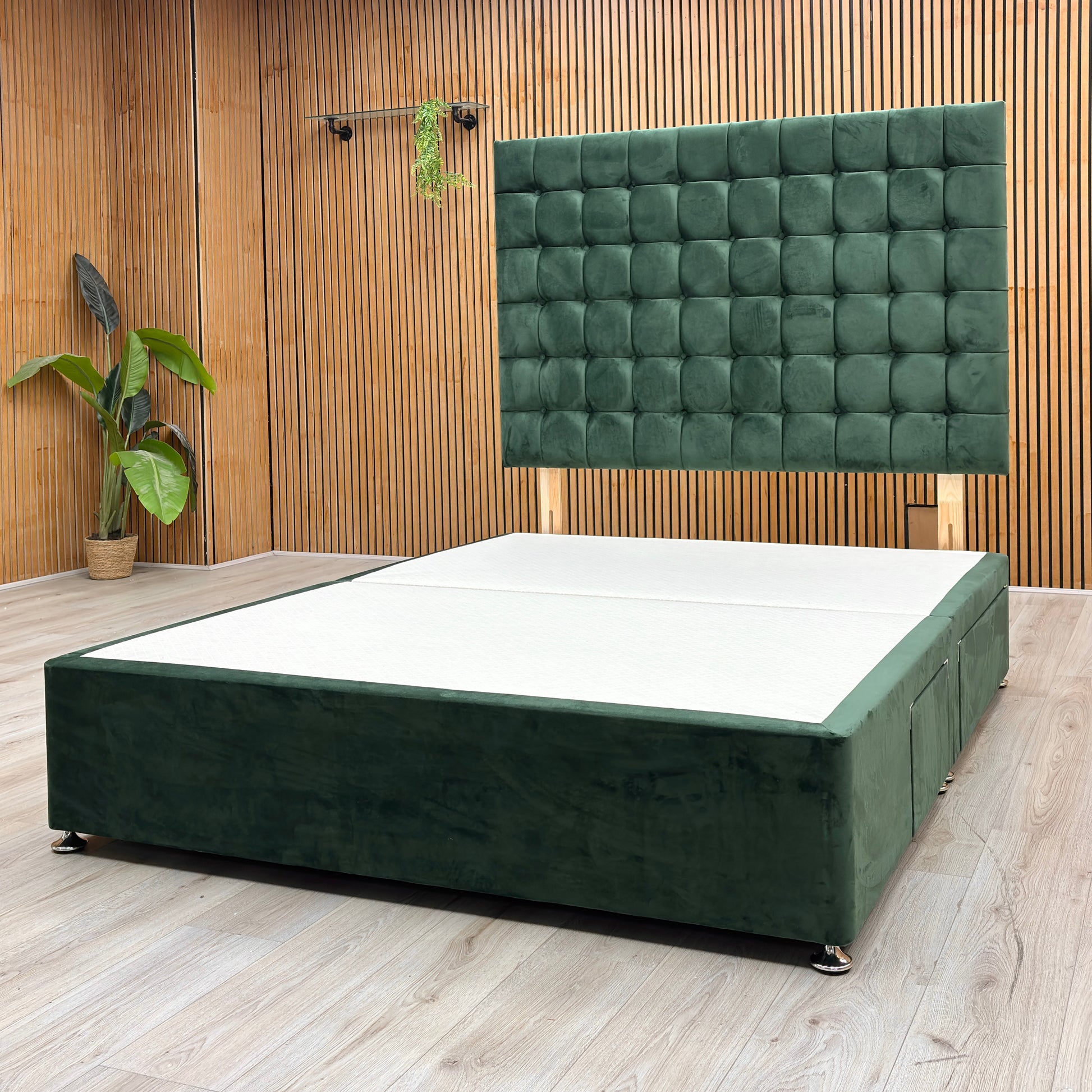 Lifestyle View Furniture Village ‘Dice’ king-size divan bed frame, showcasing a plush emerald green velvet headboard and a matching upholstered 4-drawer divan base.