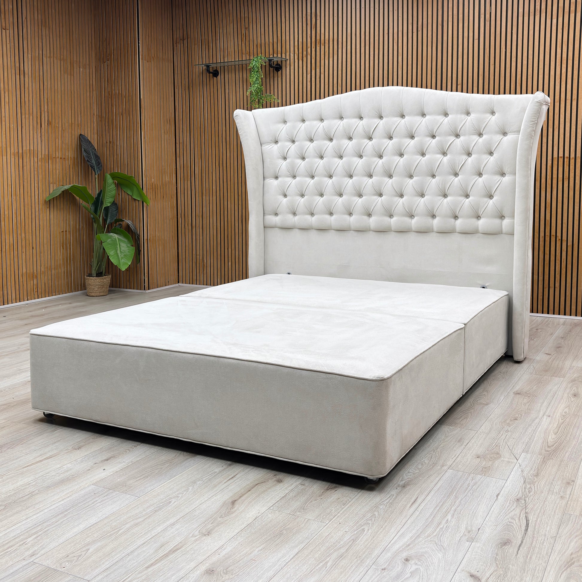 Lifestyle Shot Furniture Village Hypnos ‘Hambleden’ king-size divan bed ensemble, featuring a tall, winged floor-standing headboard and bespoke divan base upholstered in rich Imperio 903 stone grey fabric.