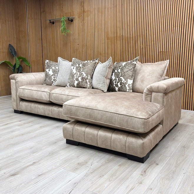 Liferstyle View DFS ‘Dolcie’ 3-seat chaise sofa, right hand facing orientation, beautifully upholstered in luxurious caramel combination Dolcie velvet with a relaxed, casual pillow back configuration.