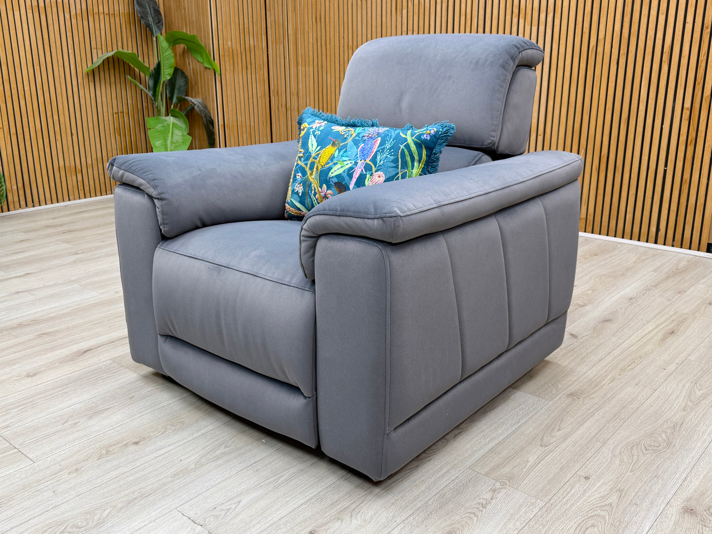 Side profile of the chair, showcasing the deep-seated cushioning and the sleek lines of the power reclining frame.