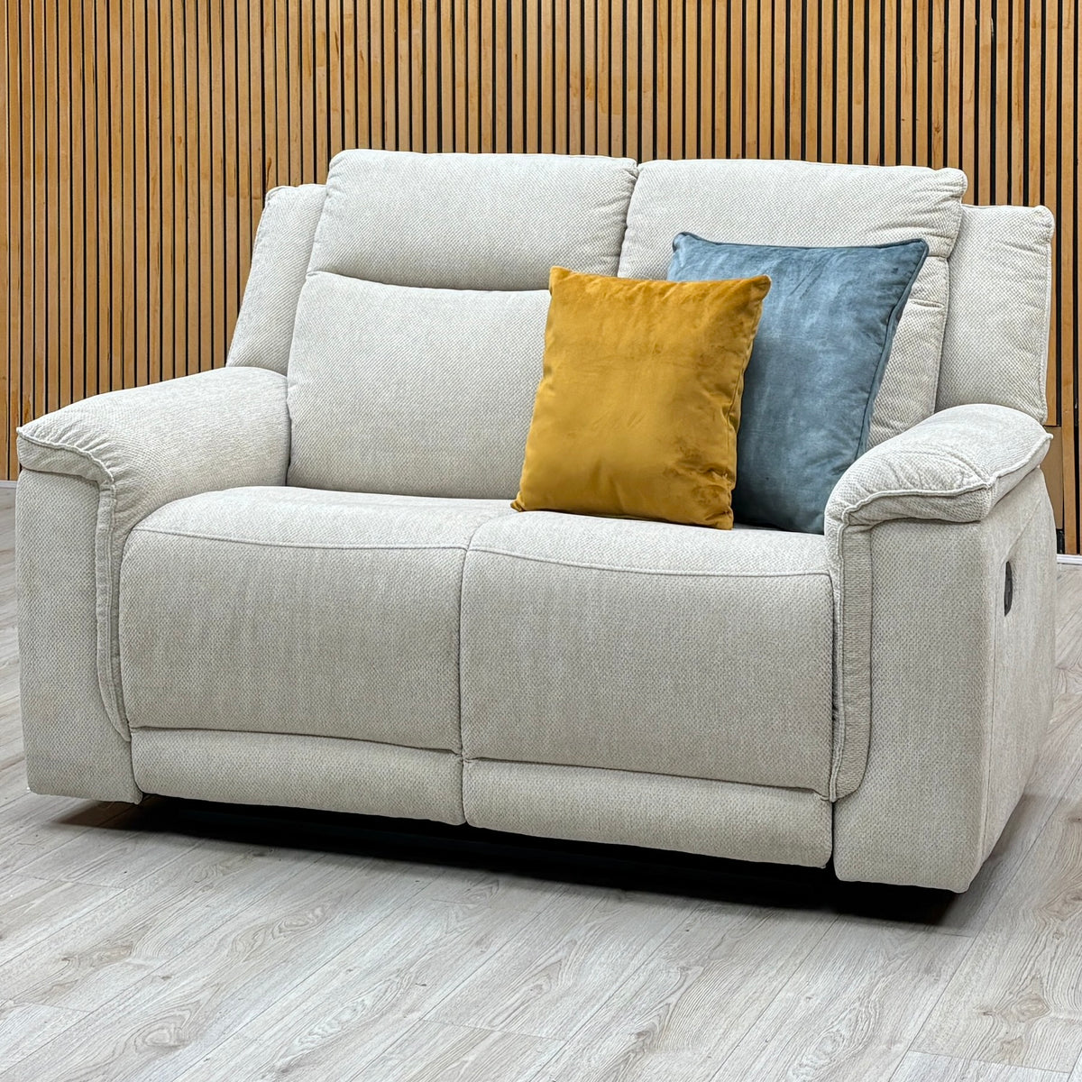 Miro natural fabric 2 seater manual recliner sofa against a slatted wooden wall on a grey wood floor