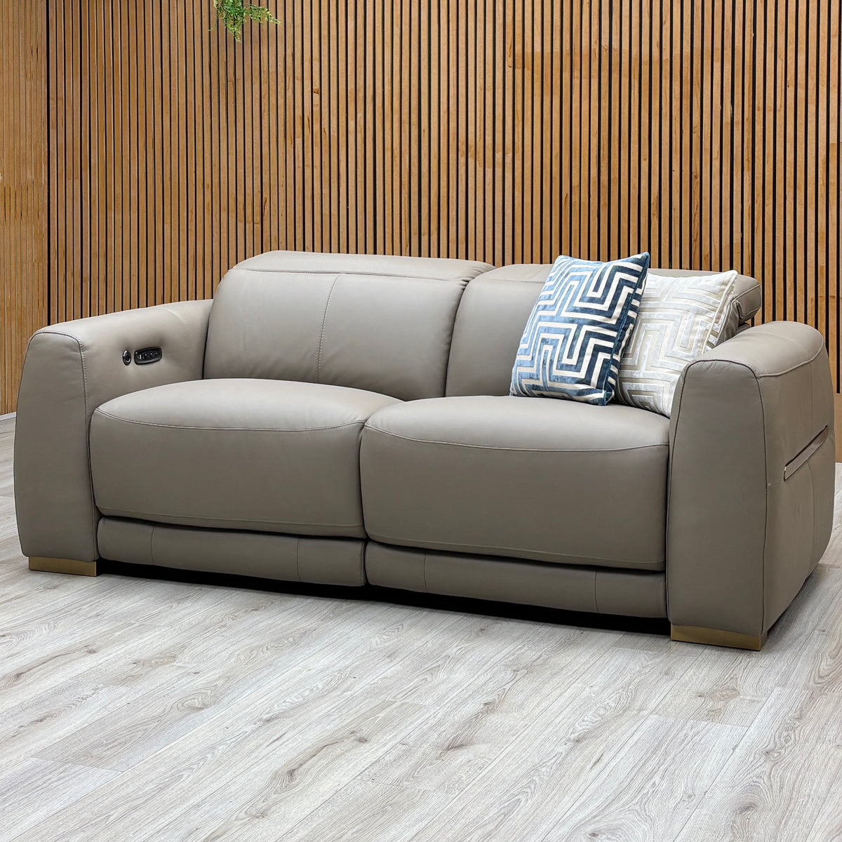 Edison taupe leather 3 seater power recliner sofa against a slatted wooden wall on a light oak floor