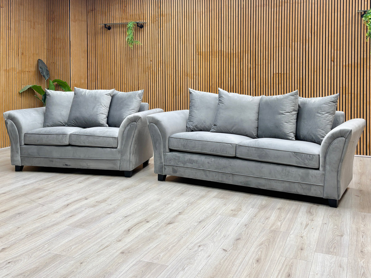 Leila grey velvet 3 + 2 seater scatter back sofa set against a slatted wooden wall on a light oak floor