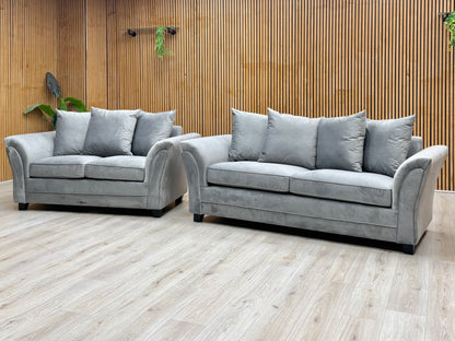 Leila grey velvet 3 + 2 seater scatter back sofa set against a slatted wooden wall on a light oak floor