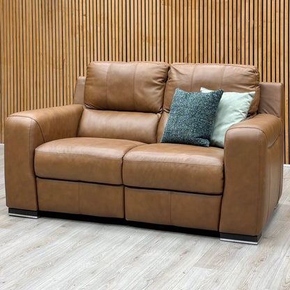 The Marinelli Viali bark brown leather 2 seater sofa from the set against a slatted wooden wall on a pale wood floor