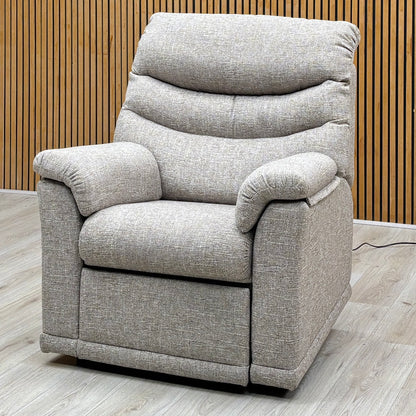 G Plan Malvern oatmeal fabric power recliner chair against a slatted wooden wall on a light oak floor