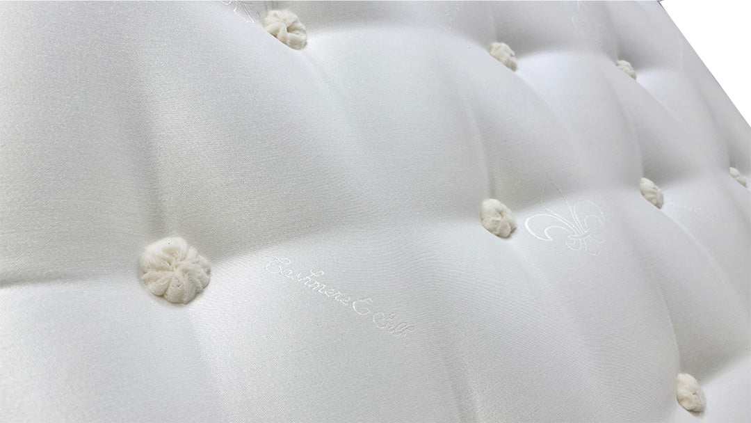 Close-up view of the top surface of the Oakley Ortho mattress, highlighting the quilted or tufted pattern and breathable fabric.