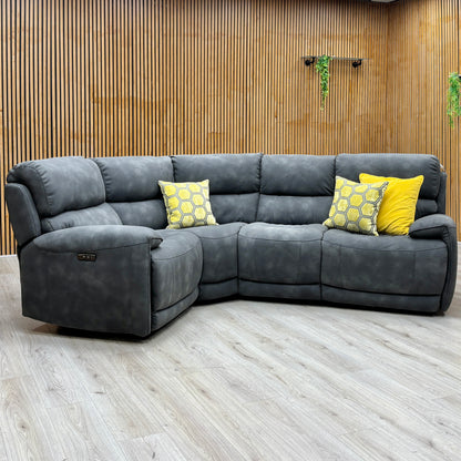 Link charcoal grey suede fabric power recliner sofa against a slatted wooden wall with the left footrest raised
