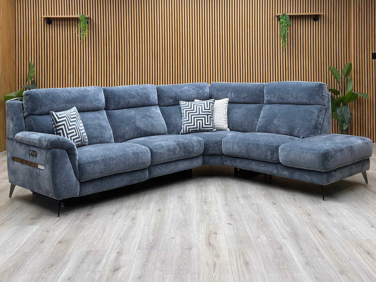 Eclipse silverish blue fabric power recliner corner sofa against a slatted wooden wall on a pale wood floor