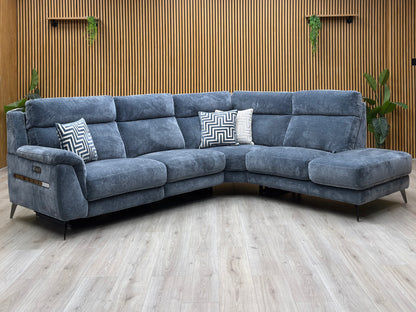 Eclipse silverish blue fabric power recliner corner sofa against a slatted wooden wall on a pale wood floor