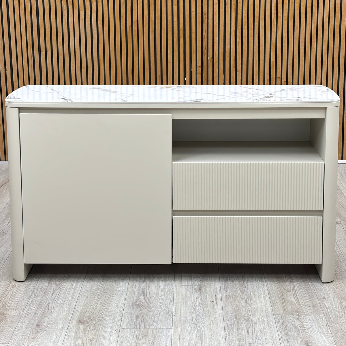 Avorio ceramic top small sideboard against a slatted wooden wall on a light oak floor