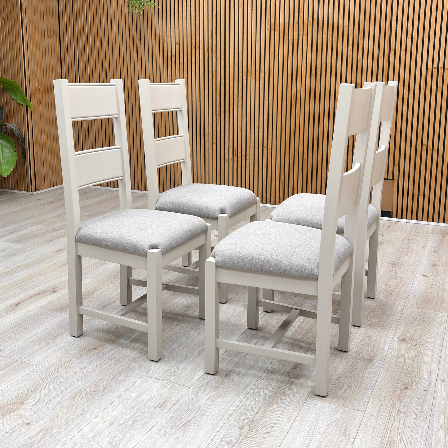 Lifestyle profile view of a Doune dining chair, emphasizing the supportive, elegant angle of the high backrest and the sturdy square leg layout.