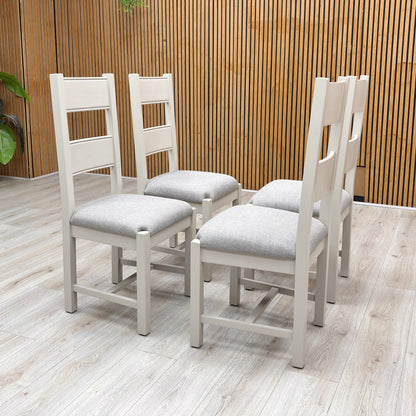 Lifestyle profile view of a Doune dining chair, emphasizing the supportive, elegant angle of the high backrest and the sturdy square leg layout.