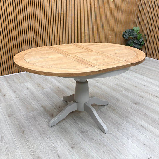 Lifestyle view of the Joseph table in its closed position, emphasizing the smooth finish and natural wood grain patterns running across the circular tabletop.