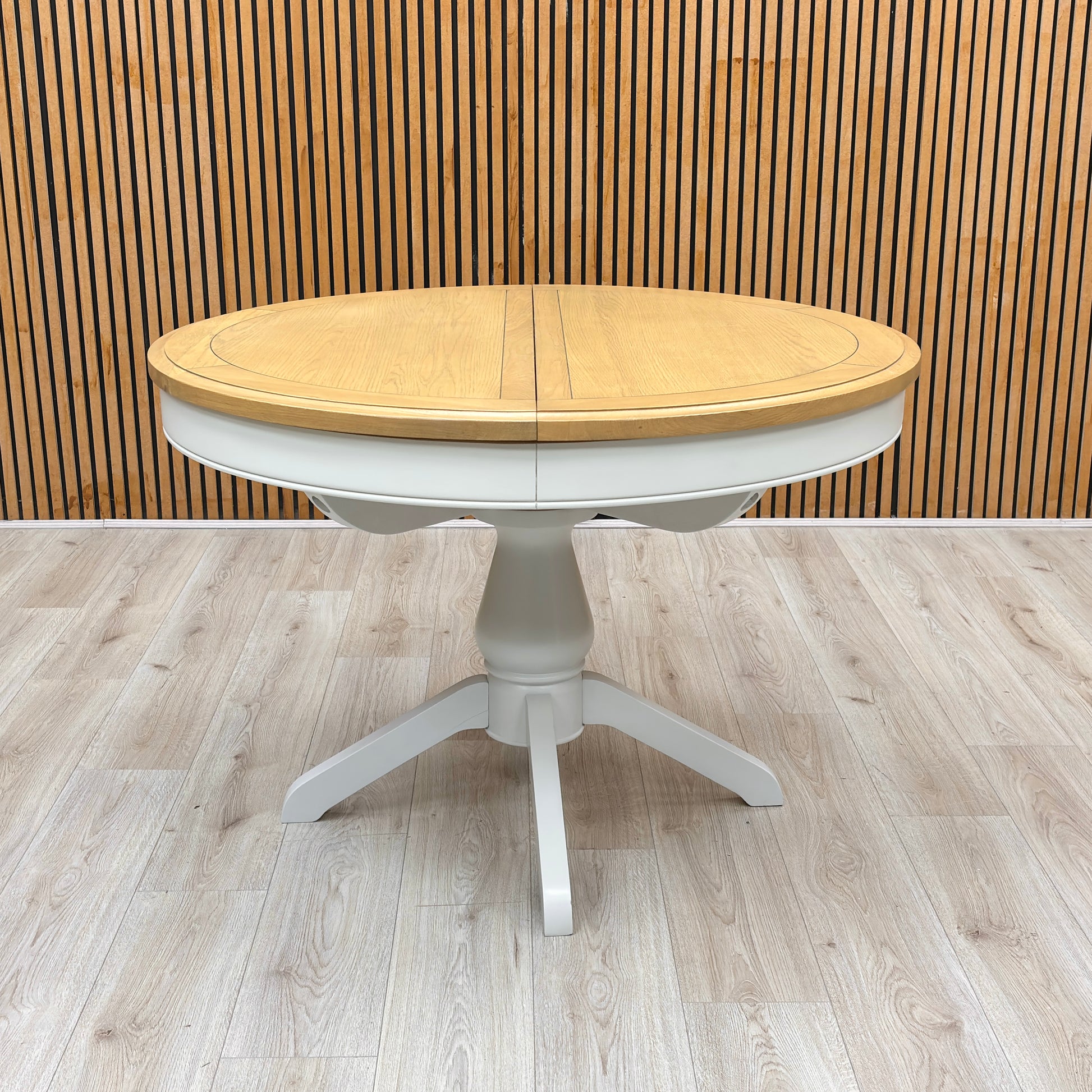 Lifestyle view of the 'Hamilton' dining table showing the tabletop surface and how the solid oak finish serves as a warm focal point for a dining space.