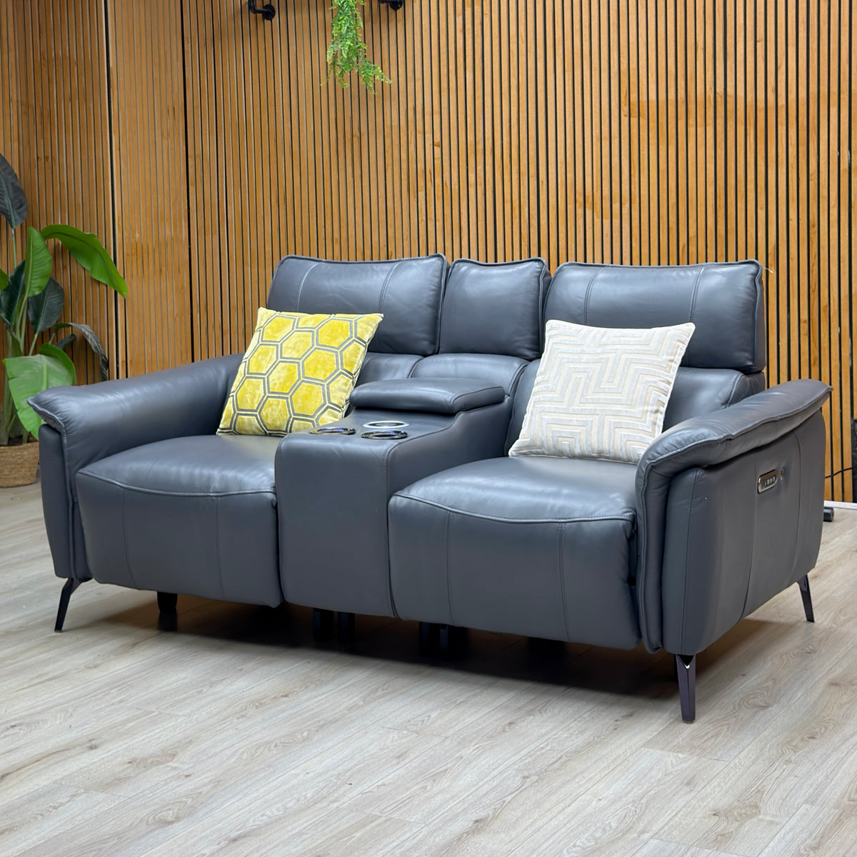 Jude lavender grey leather 2 seater power recliner against a slatted wood wall with console between the seats
