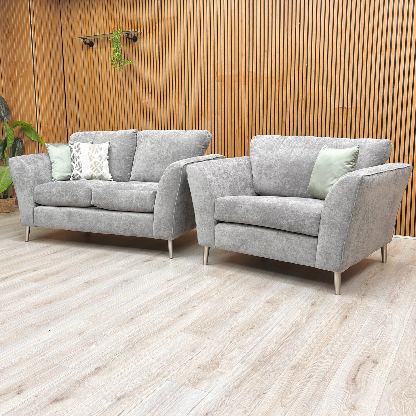 Lifestyle shot of the Lana collection in a lounge setting, showcasing the durable Kingston grey fabric and sleek structural lines.