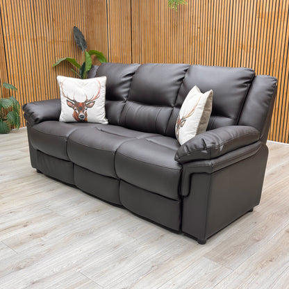 Lifestyle view of the Albion faux leather sofa, showcasing its deep, welcoming three-person seating layout, thick padded armrests, and classic cozy aesthetic.
