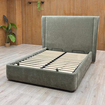 Lifestyle view of the ‘Dior’ bed frame with the mattress platform fully raised from the foot end, demonstrating the expansive, clean storage area and heavy-duty lift mechanism.