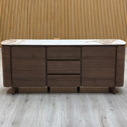 Front view of the Mekong marble effect ceramic top 2 door 3 drawer sideboard against a slatted wooden wall
