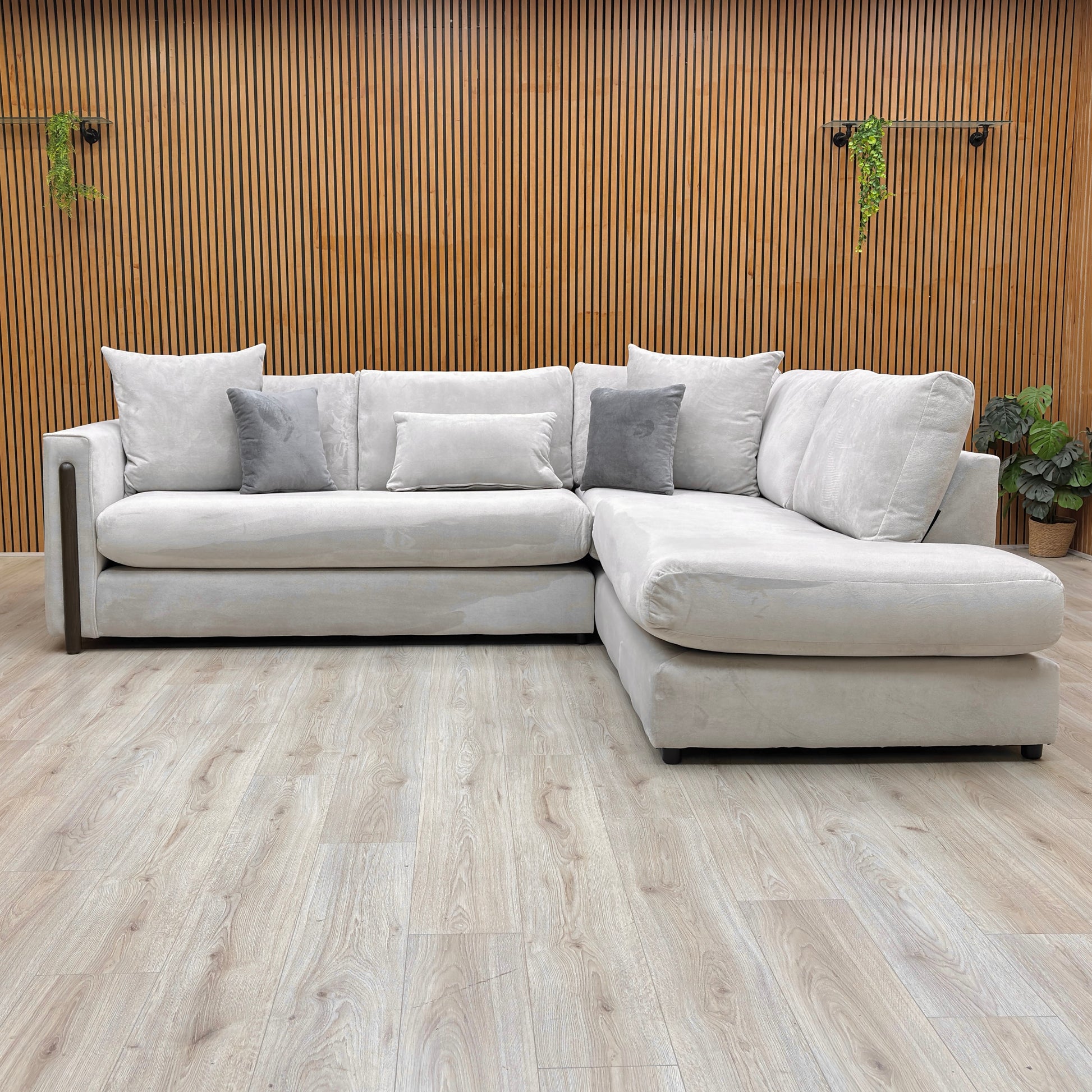 Front view of the Barney corner sofa, showing the formal back design and deep, comfortable seat cushions.