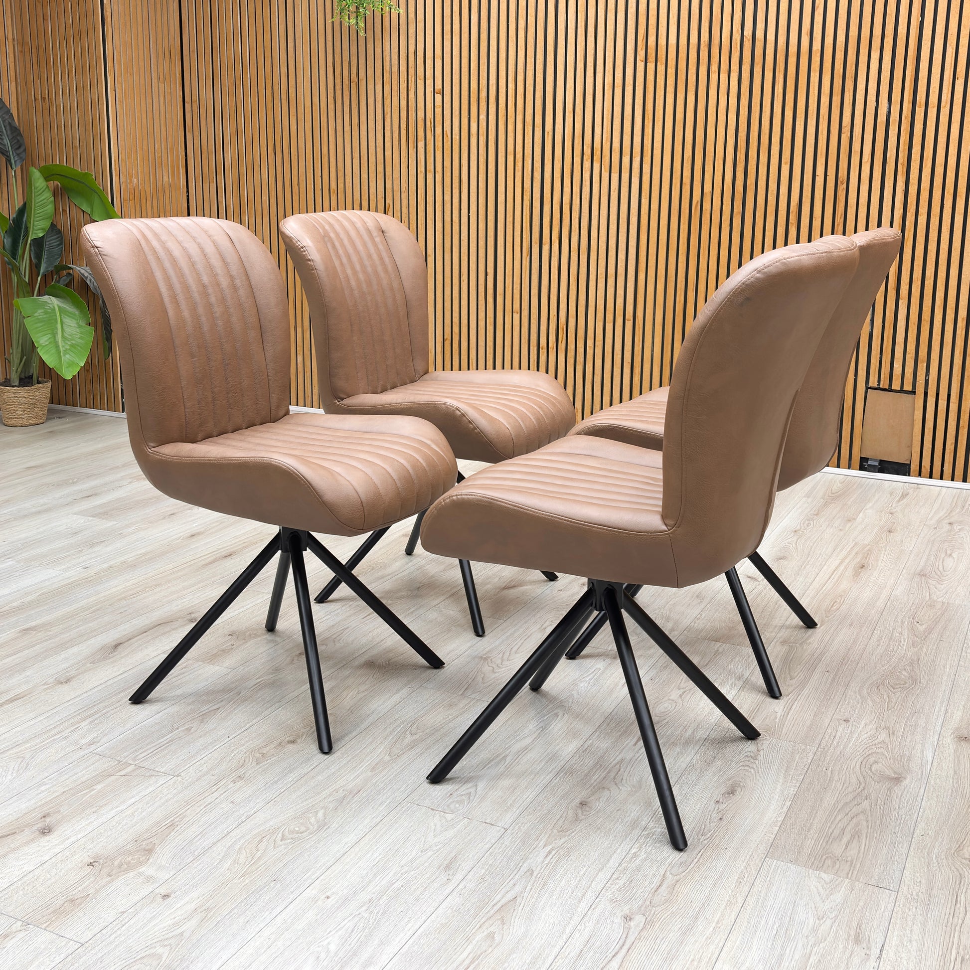 Lifestyle view of the ‘Terra’ swivel chair, emphasizing the plush deeply padded bucket seat and the rich, authentic character of the high-quality tan brown leather.