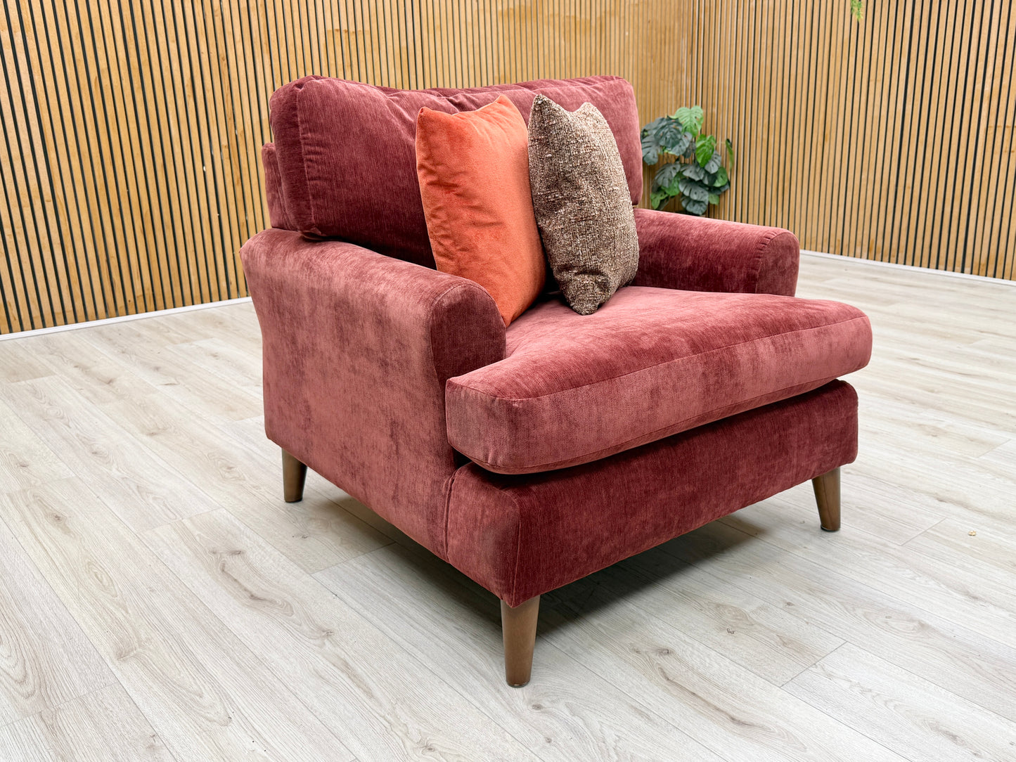 Lifestyle view of the ‘Jackson’ fabric chair, emphasizing its wide, inviting seat profile and the rich, warm color of the Paprika Red upholstery.