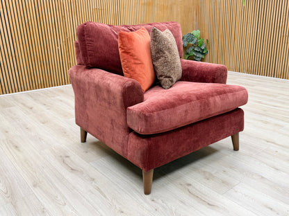 Lifestyle view of the ‘Jackson’ fabric chair, emphasizing its wide, inviting seat profile and the rich, warm color of the Paprika Red upholstery.