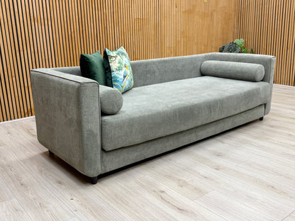 Lifestyle view of the ‘Esprit’ day bed in grey fabric, showcasing its deep seating profile and the durable weave of its modern upholstery.