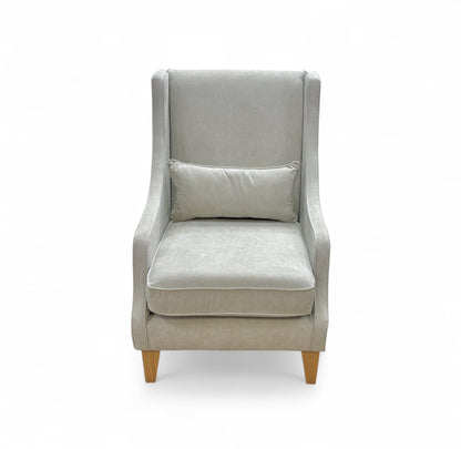 Gray armchair with a pillow on a white background