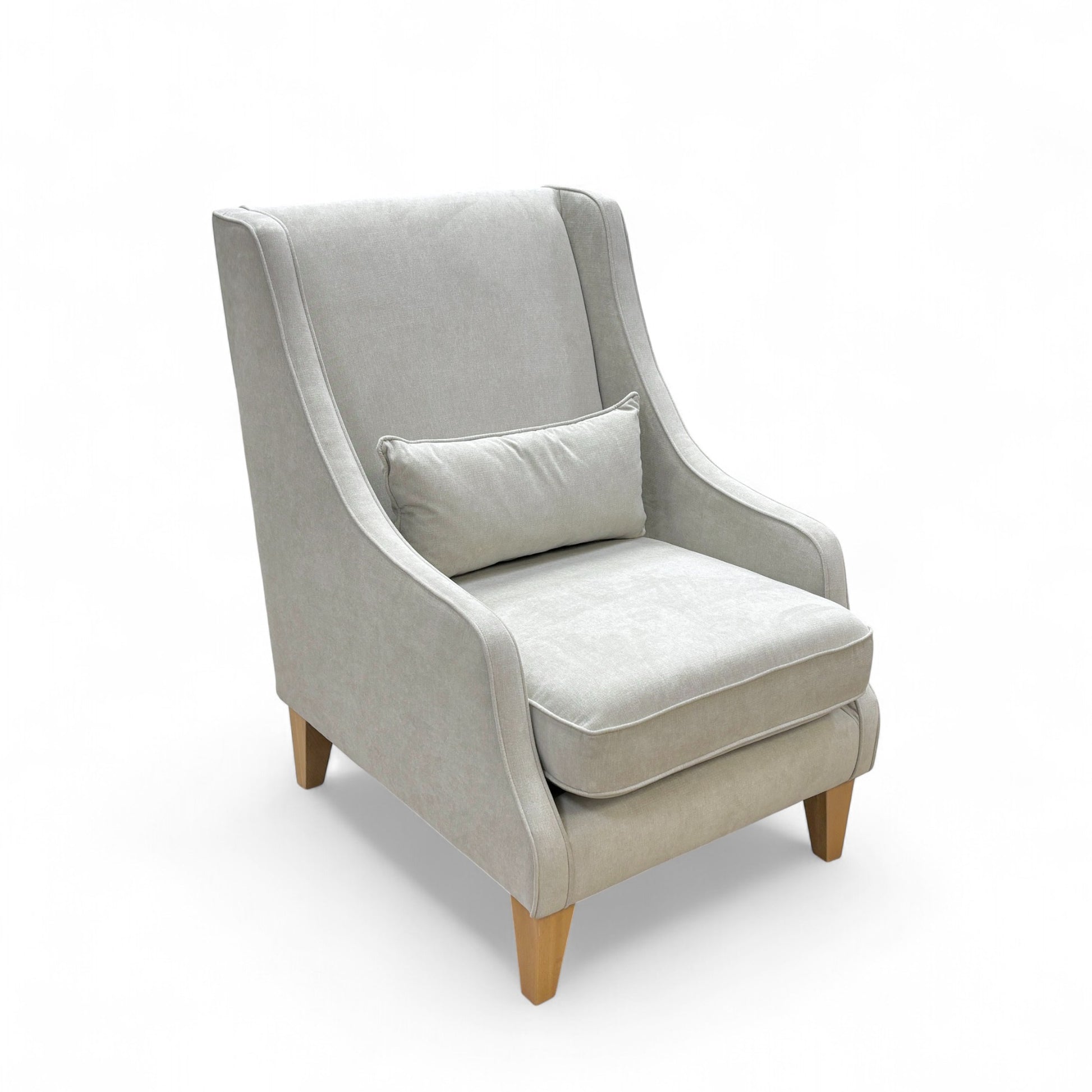 Gray armchair with a cushion on a white background