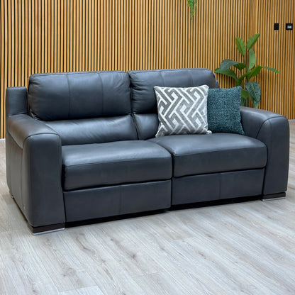 Marinelli Viali grey leather 3 seater power recliner sofa against a slatted wooden wall on a light wood floor