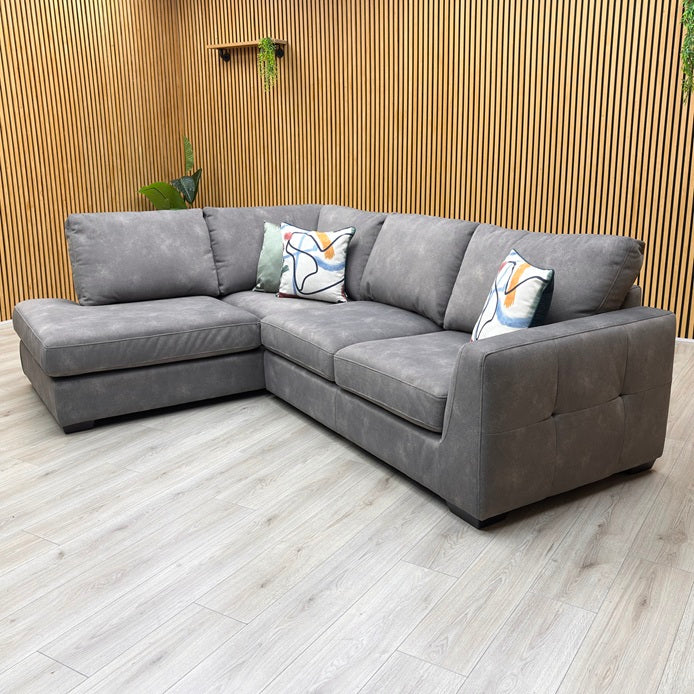 studio angle highlighting the elongated chaise end profile, plush seating arrangement, and sleek, minimalist track armrest.