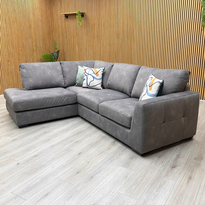 studio angle highlighting the elongated chaise end profile, plush seating arrangement, and sleek, minimalist track armrest.