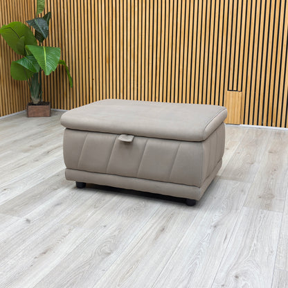 studio angle showcasing the rectangular footstool with its top cushion lid fully raised, revealing a spacious internal storage compartment