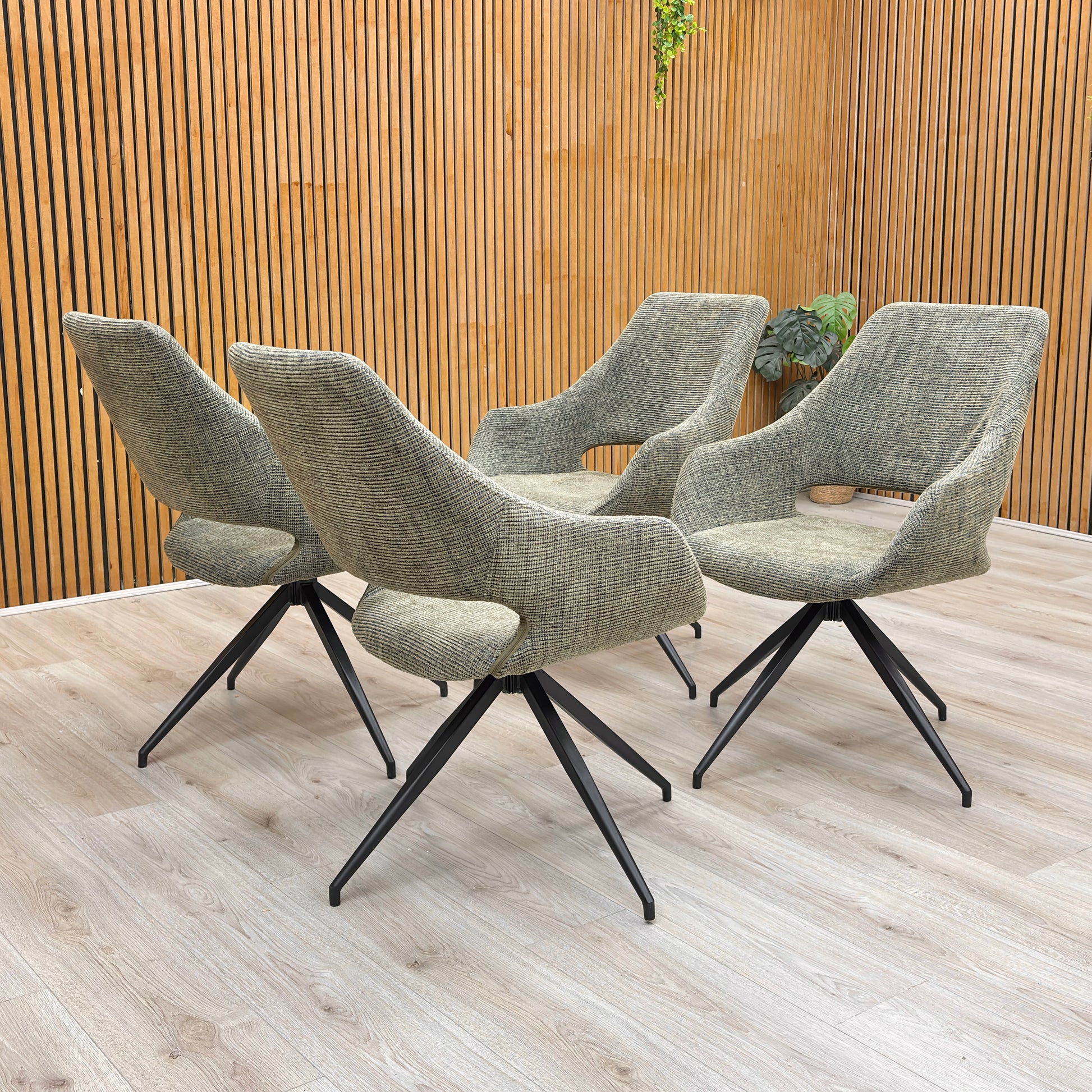 Lifestyle shot of the Sage Green Tweed Charlotte dining chair, showing its modern design.